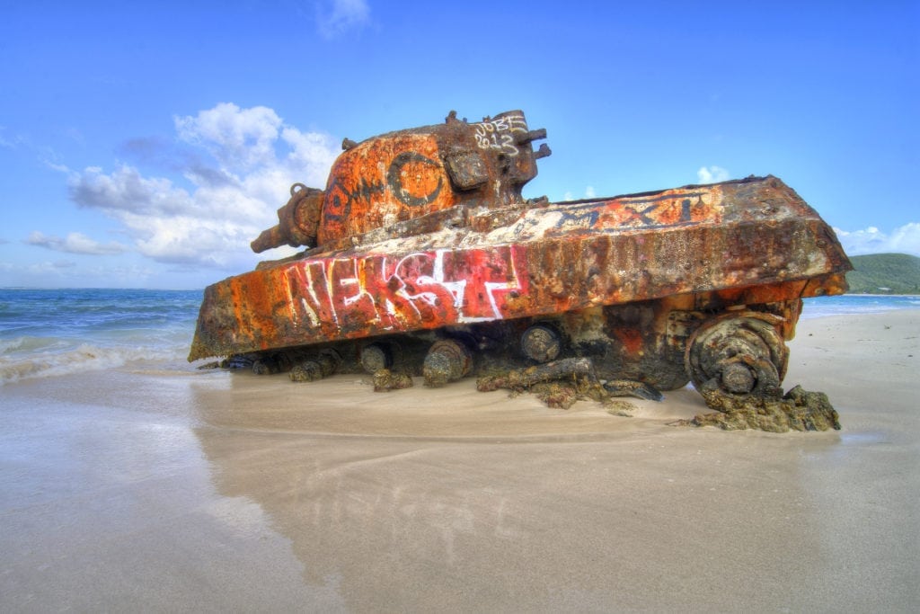 Things to Do In Puerto Rico.  
Old remnant tank partially sunk in sand at Flamenco Beach on the tropical island of Isla Culebra, Puerto Rico